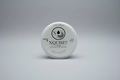 Xquisit Luxe coconut body butter container on a textured surface